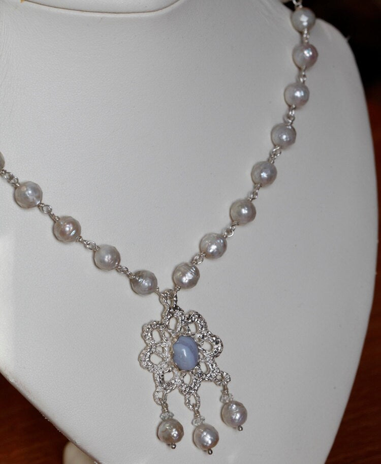 Crocheted silver lace pendant